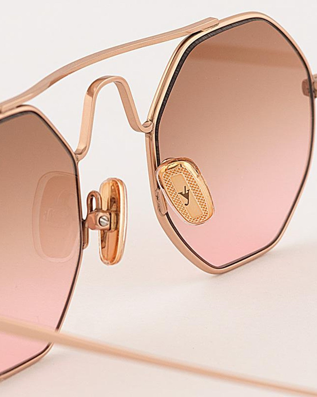 Close-up of the bridge and nose pads showing engraved logo detail on EYEPETIZER SOHO C.9-44 sunglasses.