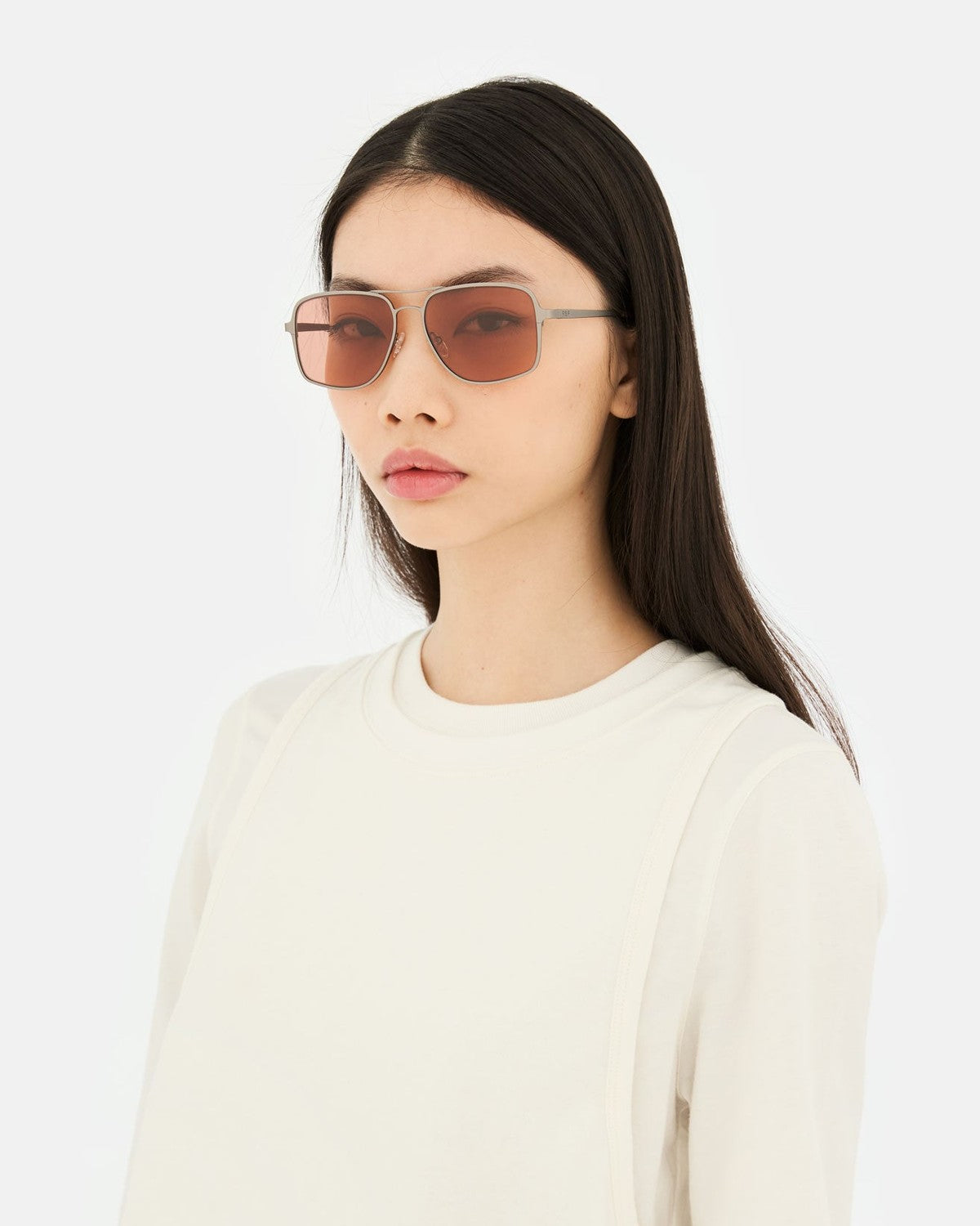 Model wearing RETROSUPERFUTURE Spliff Boogie sunglasses with a white crewneck top.