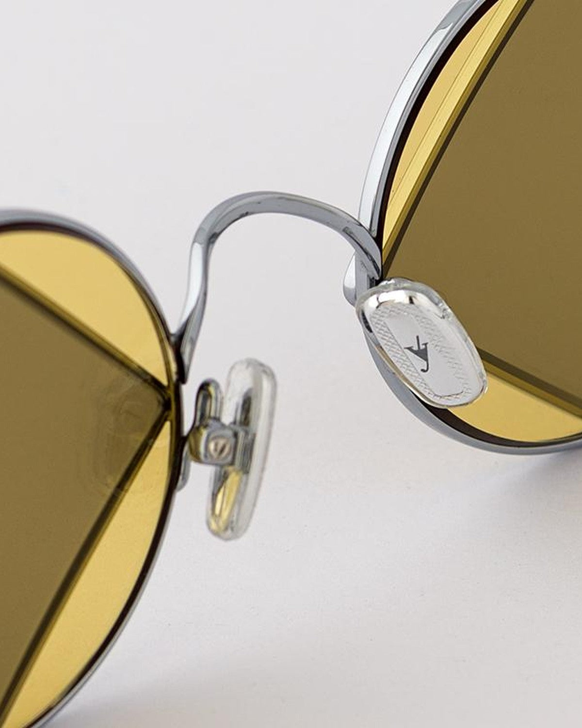 Detail of the bridge and branded medallion on EYEPETIZER SQUARE C.1-7 sunglasses.