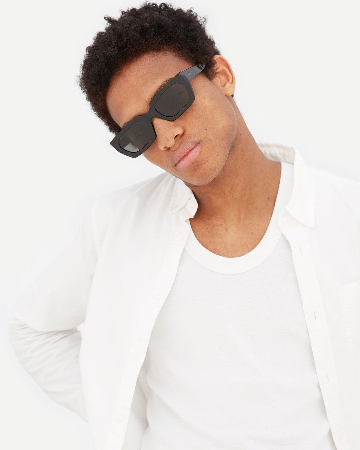Model wearing RETROSUPERFUTURE Teddy Black sunglasses with head tilted.