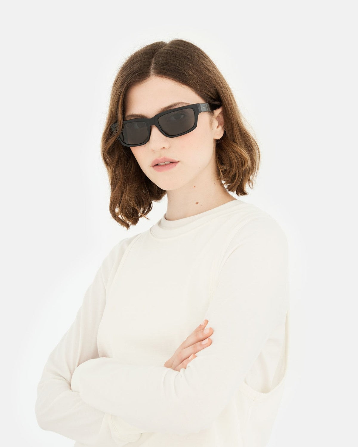 Model wearing RETROSUPERFUTURE Thelonius Black sunglasses indoors.