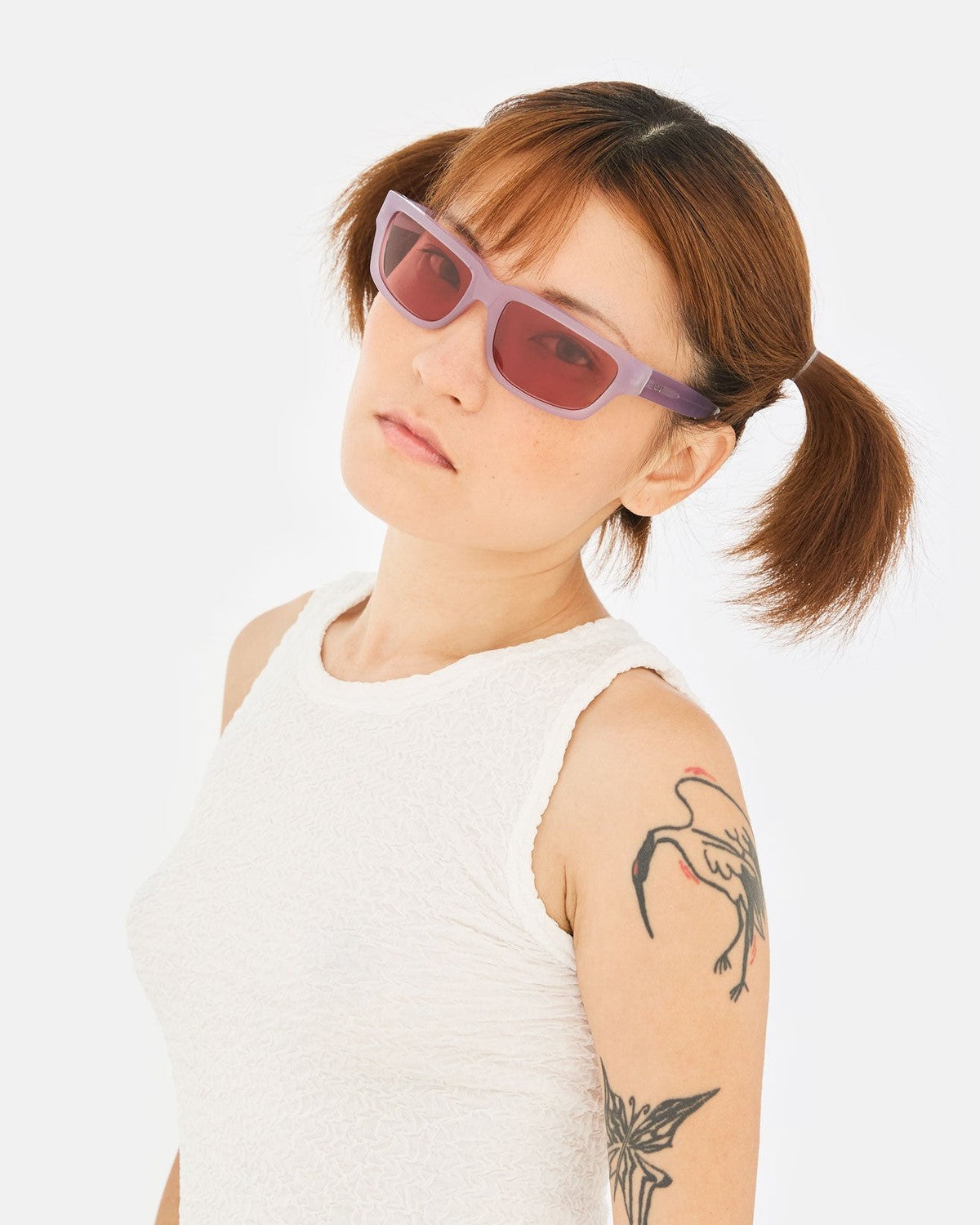 Model wearing RETROSUPERFUTURE Thelonius Light Purple sunglasses.