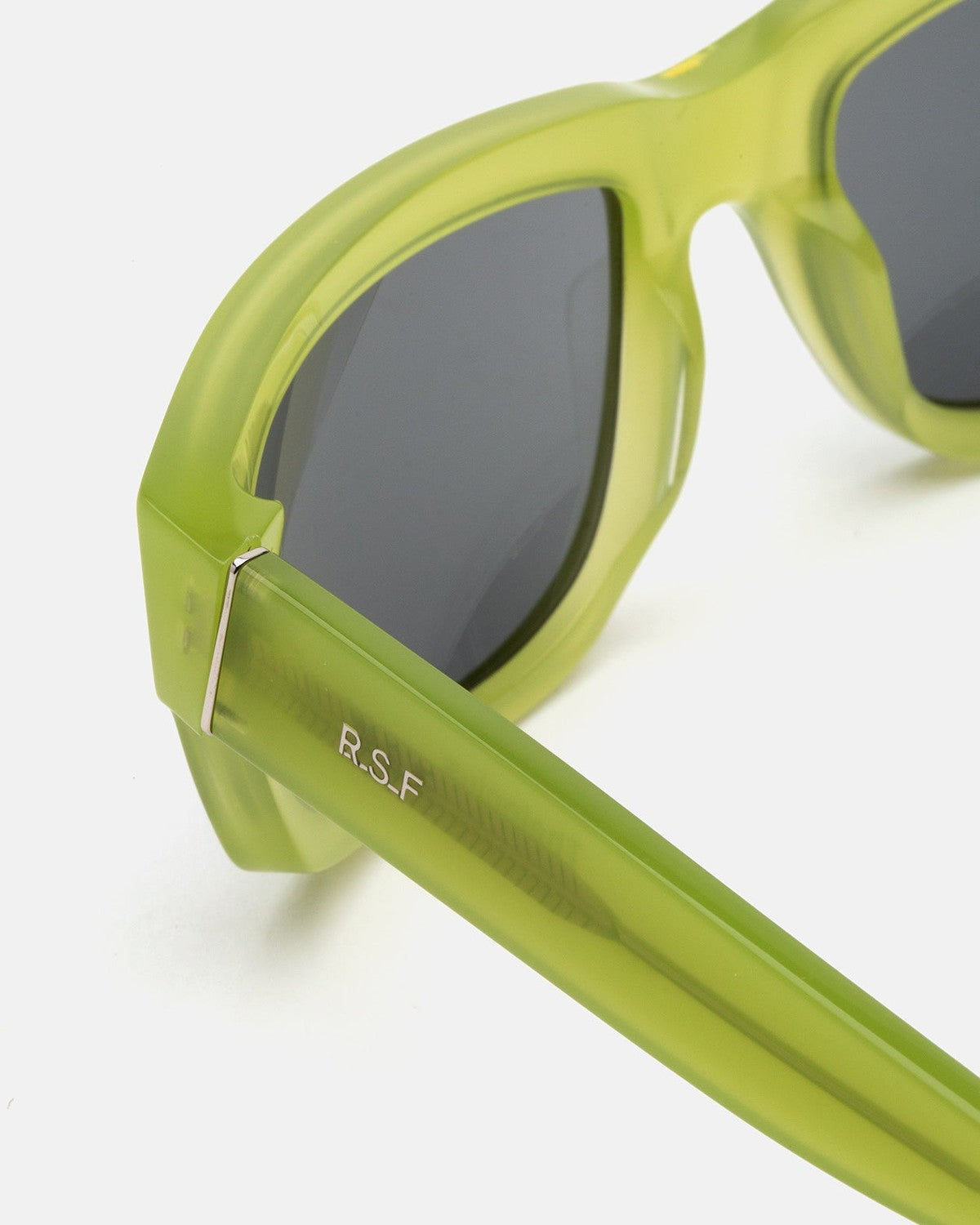 Close-up of the temple hinge on RETROSUPERFUTURE Thelonius Lime sunglasses.