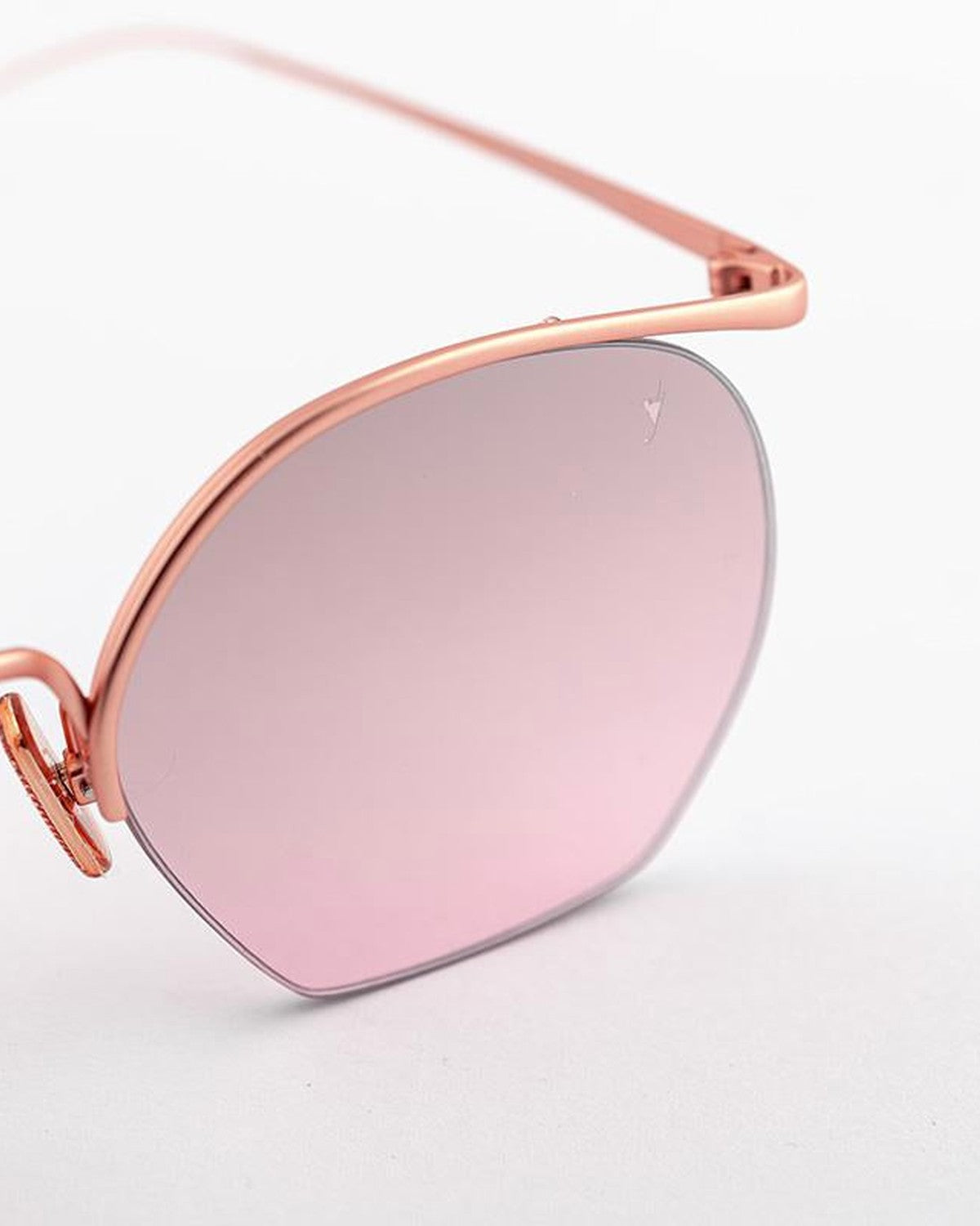 Angled close-up of the rose gold frame and pink lens on EYEPETIZER TIBERIO C.9-OP-44F sunglasses.