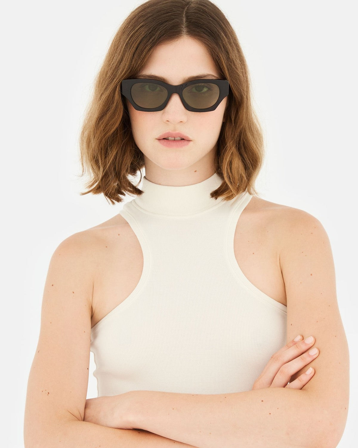 Model with shoulder-length brown hair wearing RETROSUPERFUTURE Tono 3627 sunglasses.