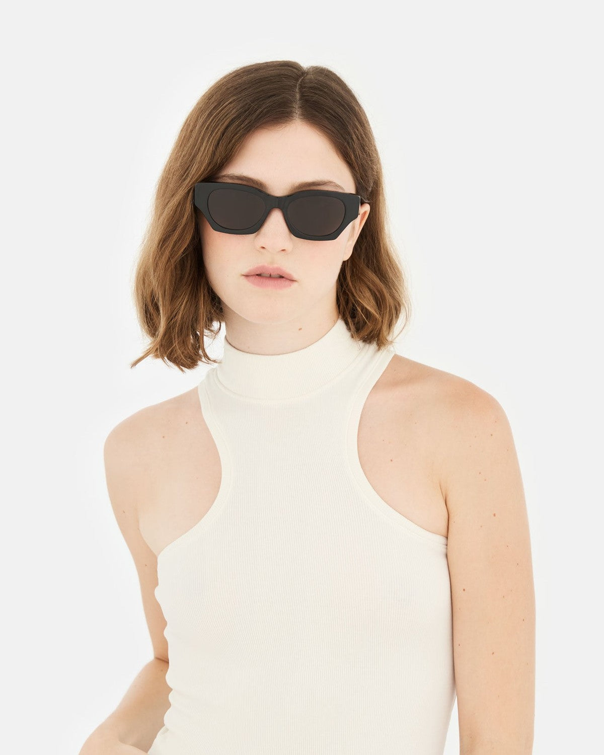 Model wearing RETROSUPERFUTURE Tono Black sunglasses with a turtleneck top.