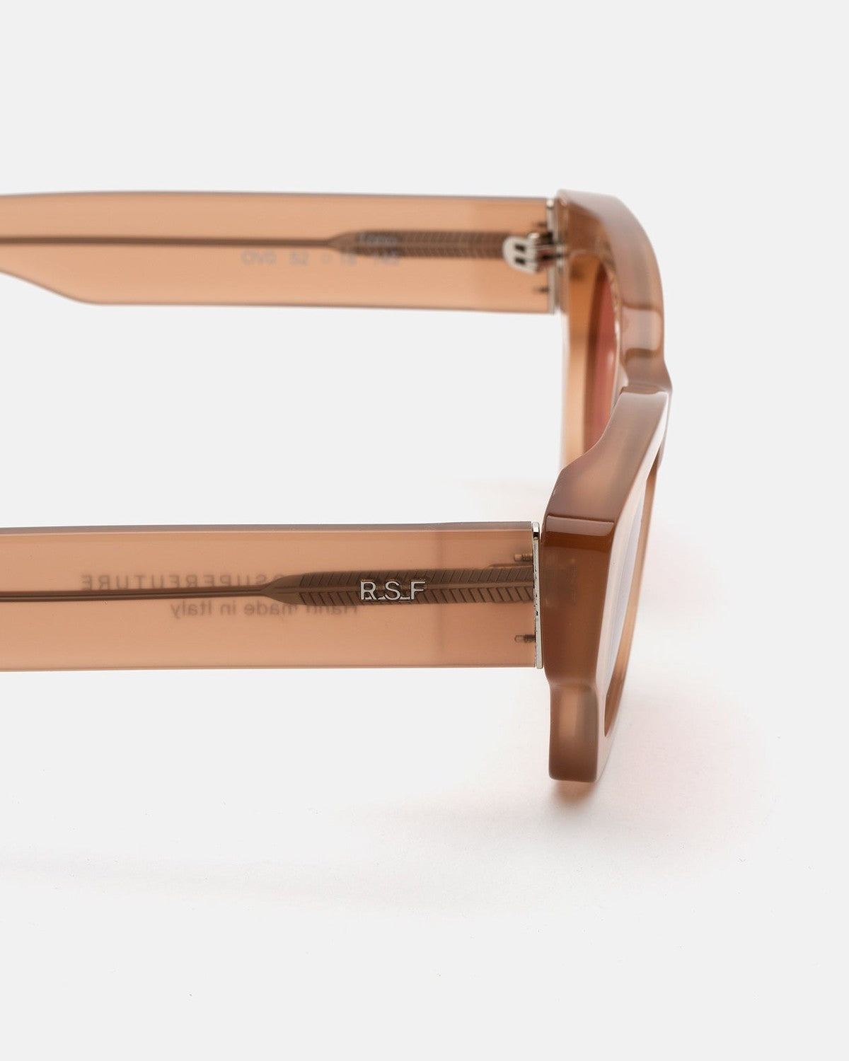 Close-up of the temple and hinge on RETROSUPERFUTURE Tono Light Brown sunglasses.