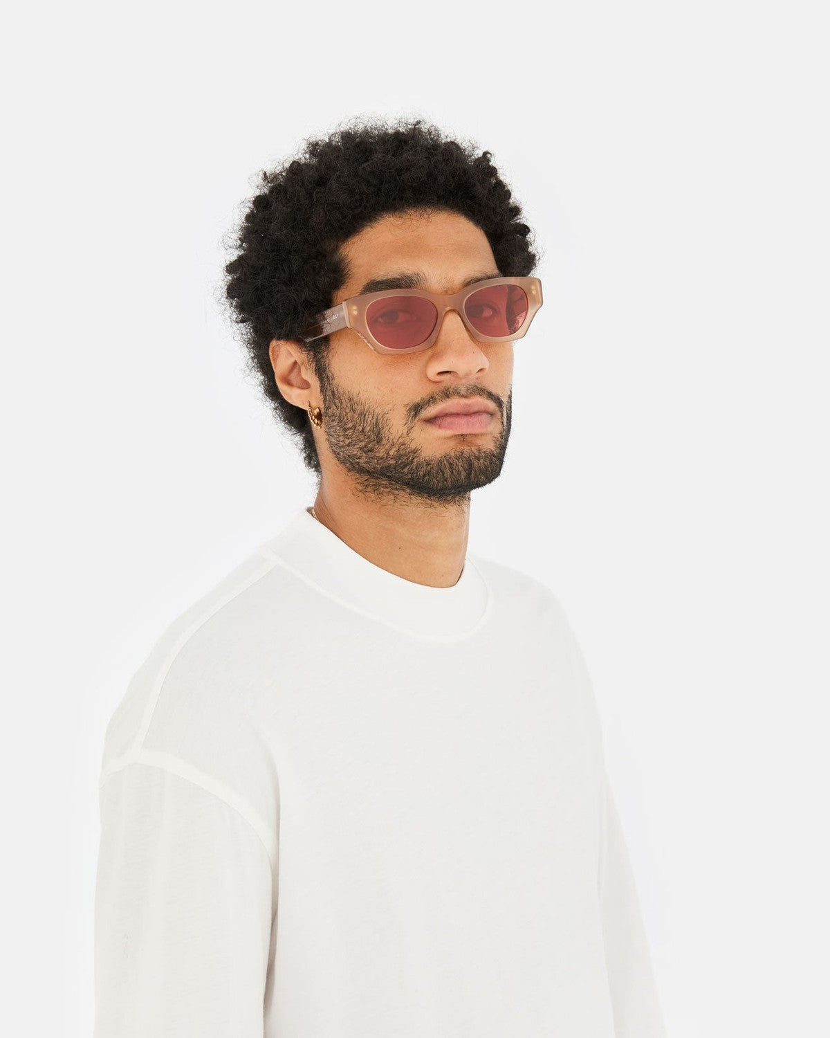 Model wearing RETROSUPERFUTURE Tono Light Brown sunglasses in white sweatshirt.