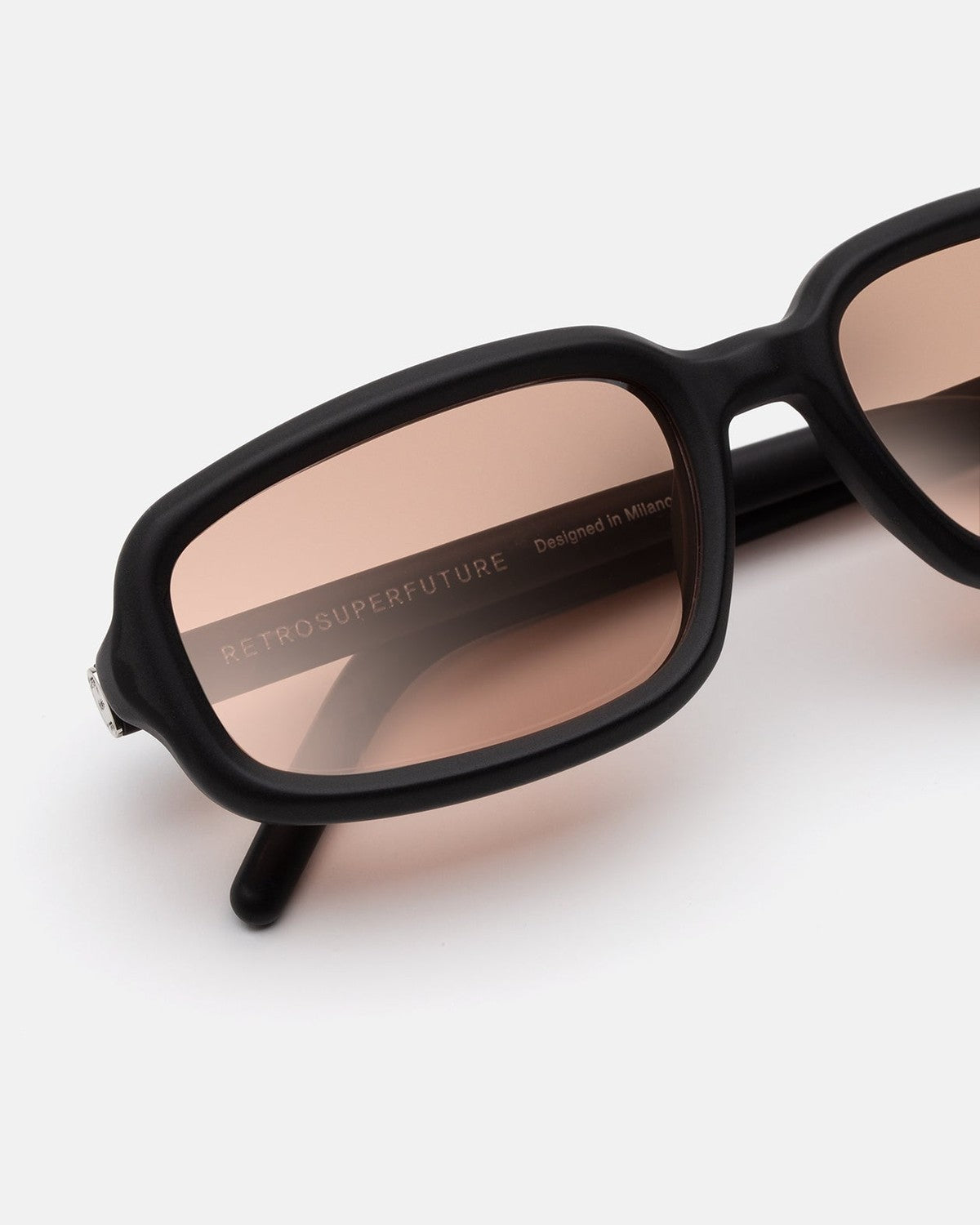 Close-up of the lens and temple detail on RETROSUPERFUTURE Troll Black Matte sunglasses.