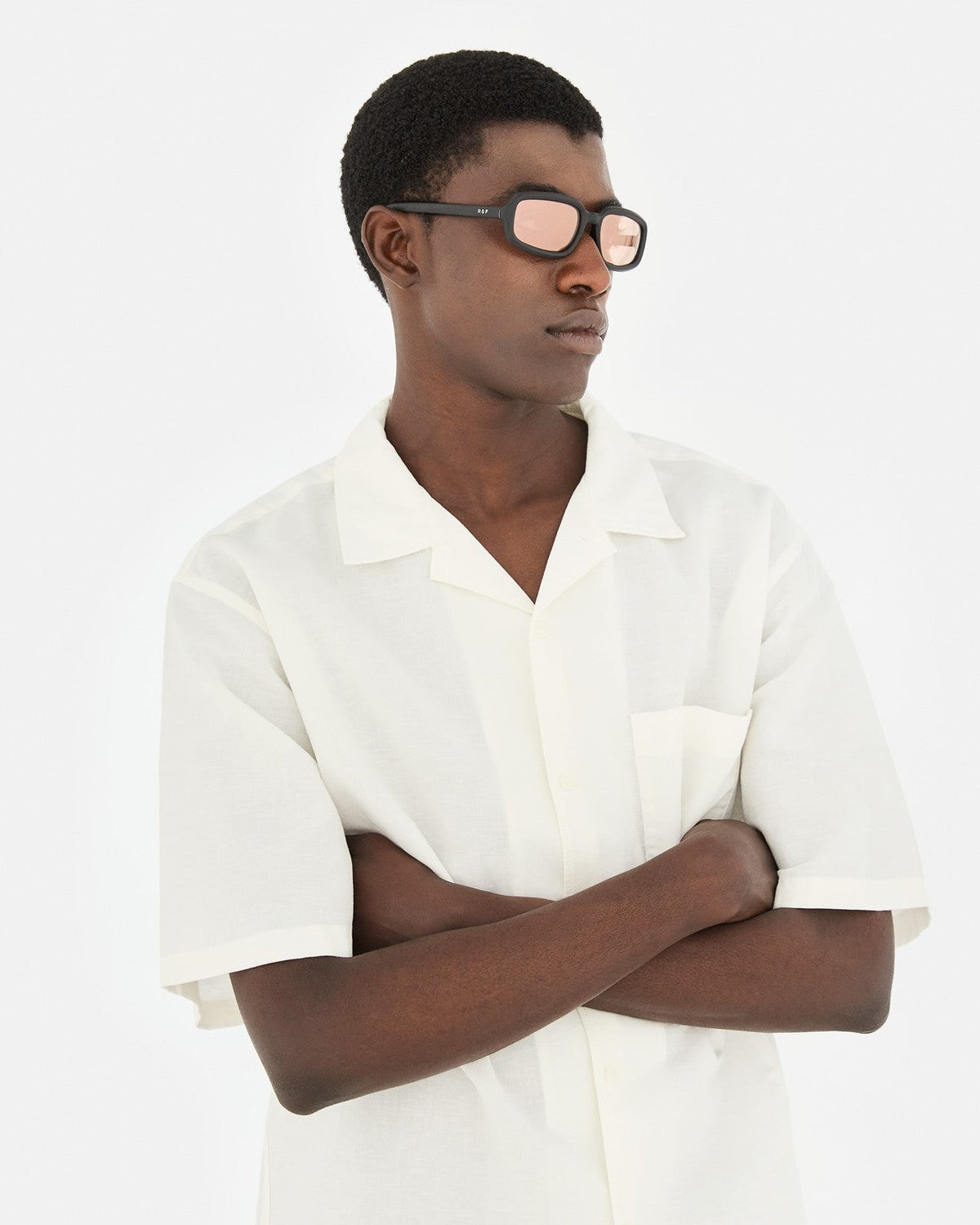 Side profile of model wearing RETROSUPERFUTURE Troll Black Matte sunglasses.