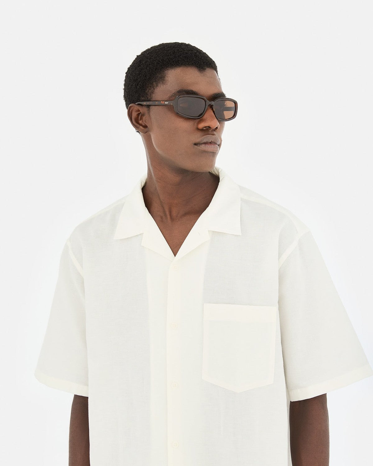 Model wearing RETROSUPERFUTURE Troll Burnt Havana sunglasses outdoors.