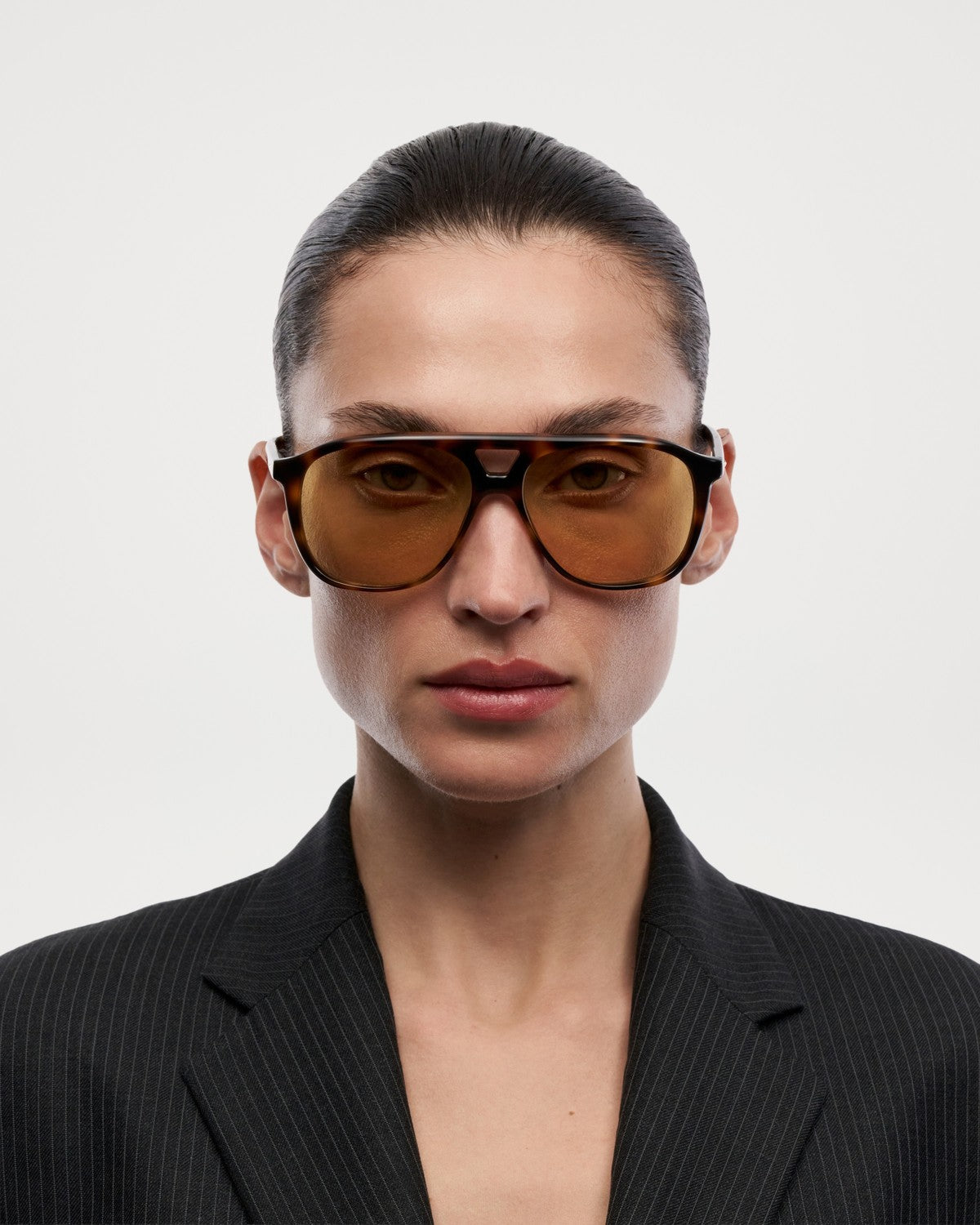Model wearing CHIMI Uma Tortoise Yellow sunglasses in studio setting.