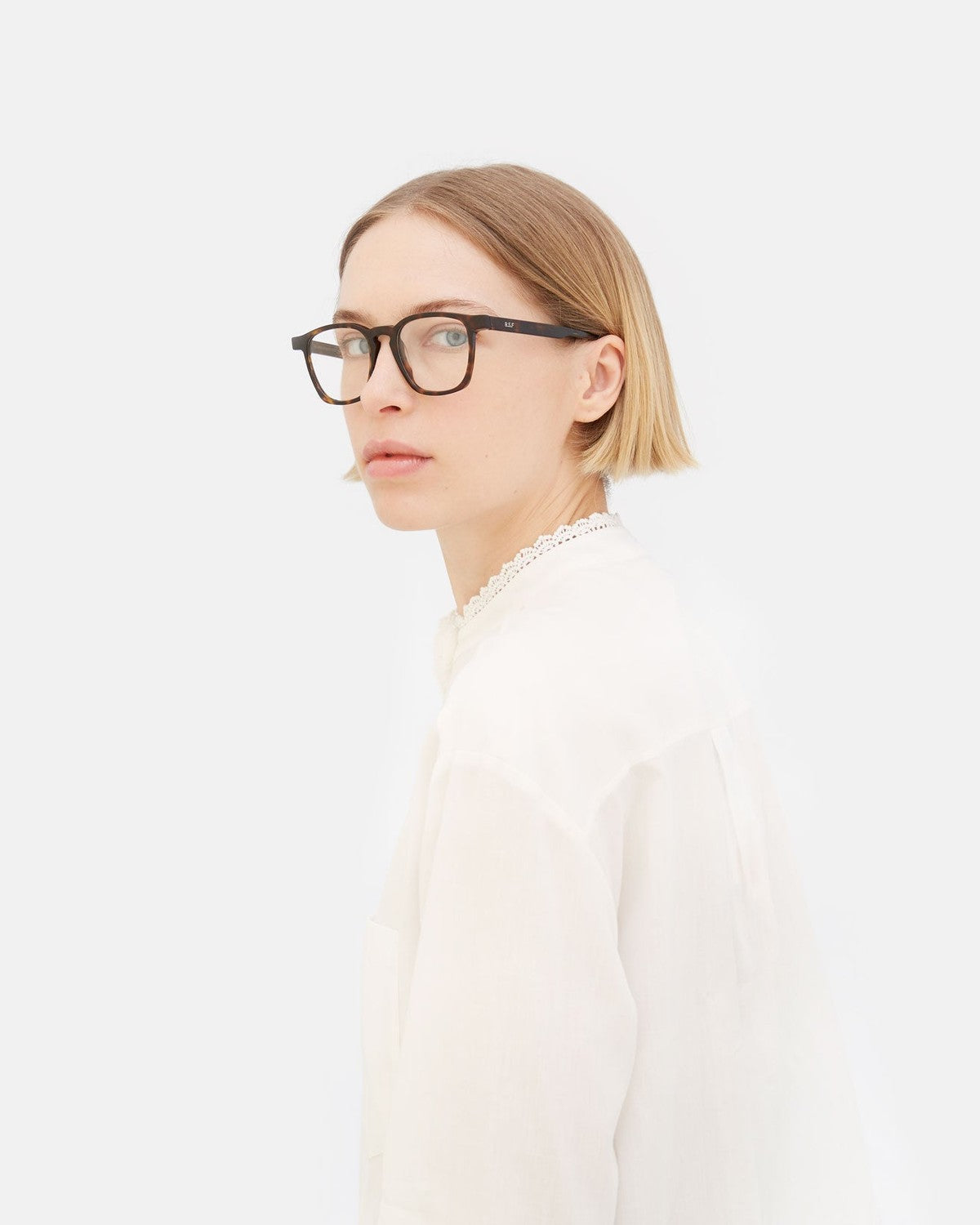 Model wearing RETROSUPERFUTURE Unico 3627 eyeglasses, side profile.