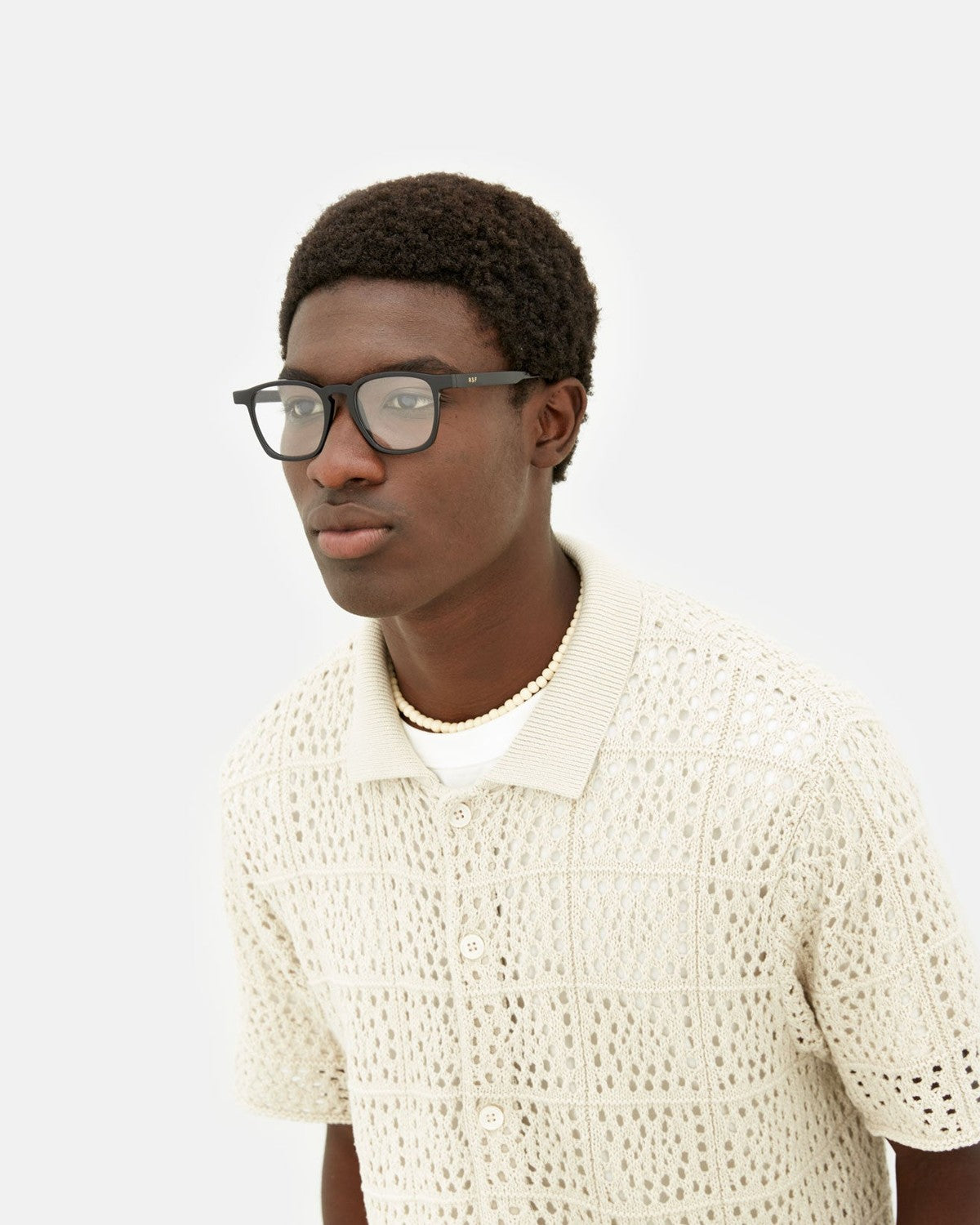 Model wearing RETROSUPERFUTURE Unico Nero eyeglasses, side profile.