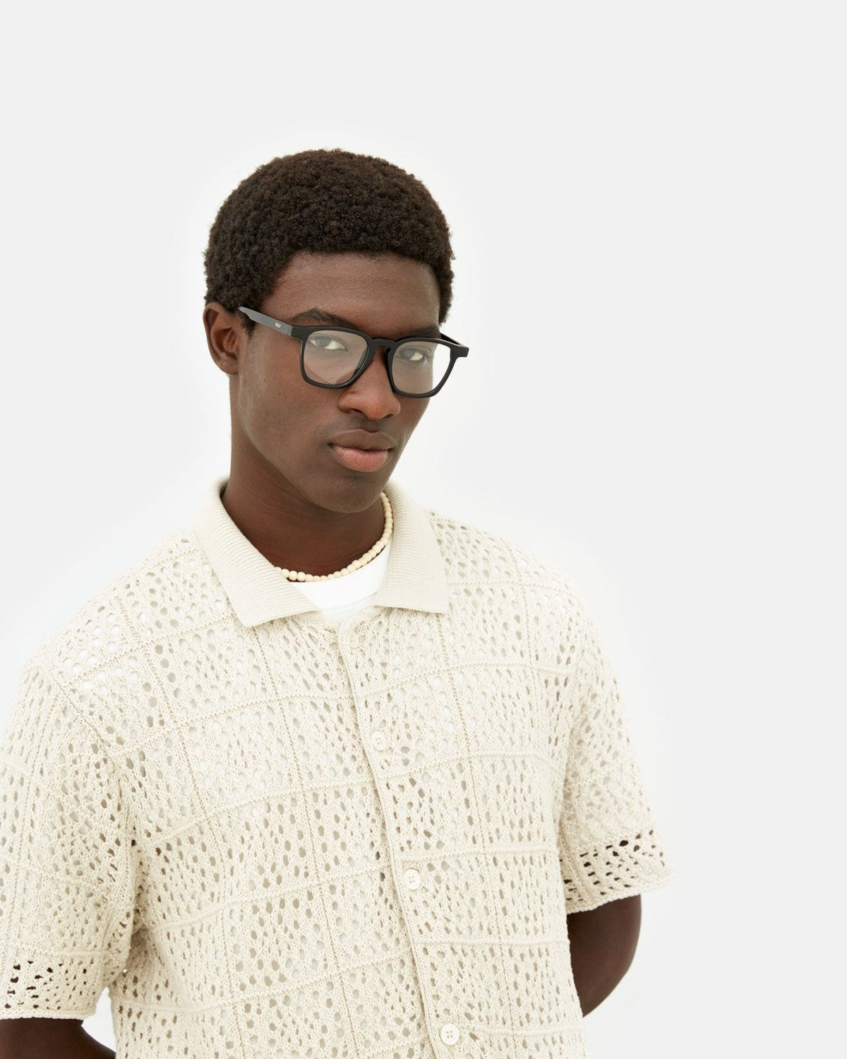 Model wearing RETROSUPERFUTURE Unico Nero eyeglasses, three-quarter view.