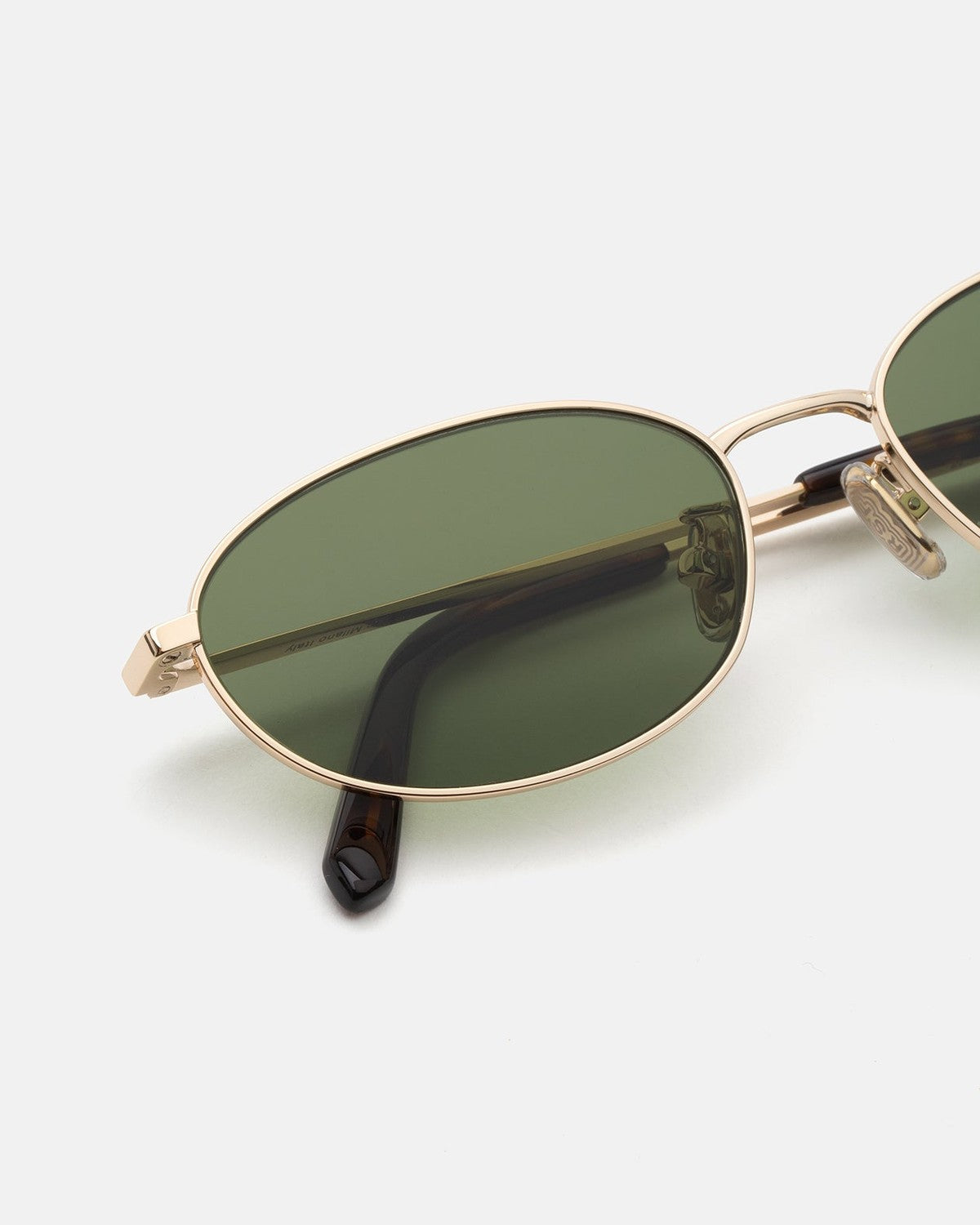 Close-up of the oval lens and metal bridge on RETROSUPERFUTURE Uovo Classico sunglasses.