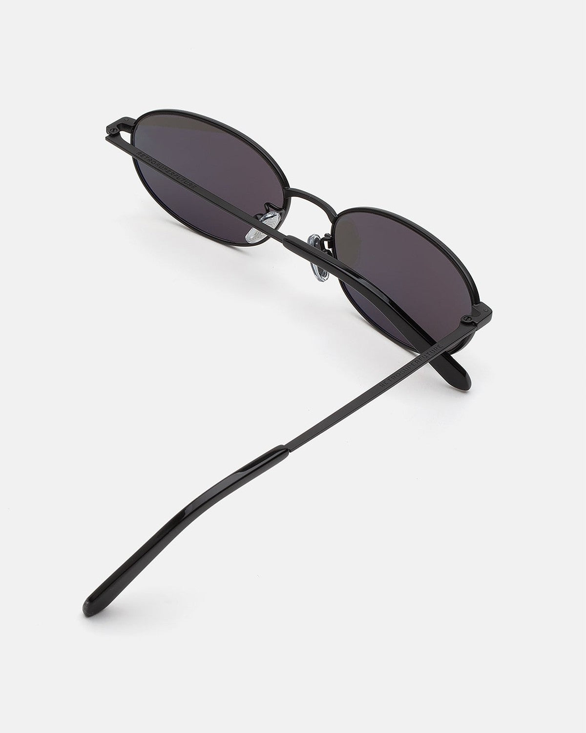 Overhead view of RETROSUPERFUTURE Uovo Nero sunglasses with temple extended.