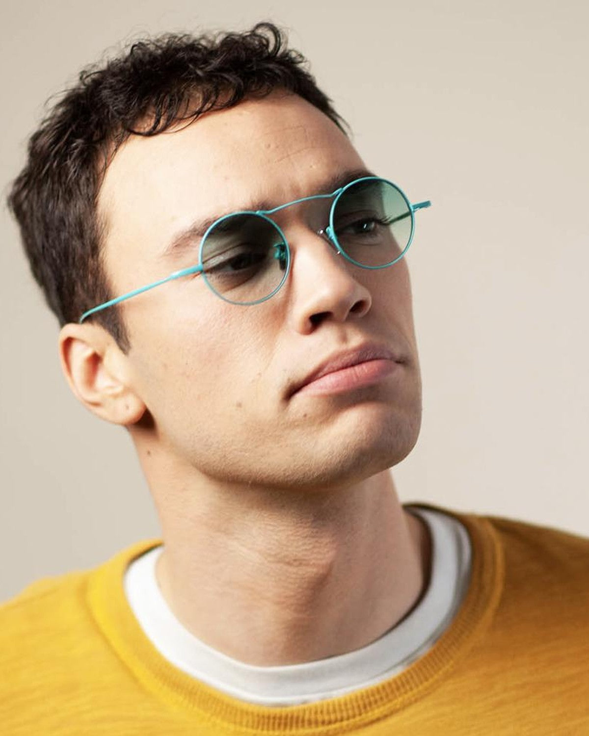 Model wearing EYEPETIZER VALENTIN C.14-21 sunglasses with a yellow sweater.