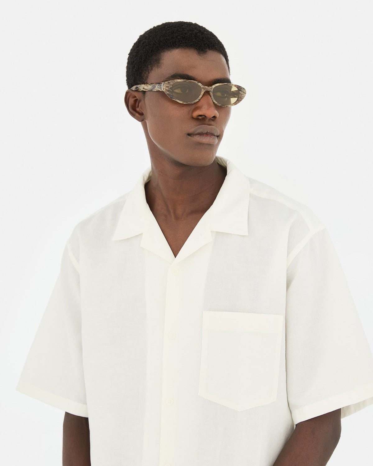 Model wearing RETROSUPERFUTURE Vega Graffiato sunglasses with a white shirt.