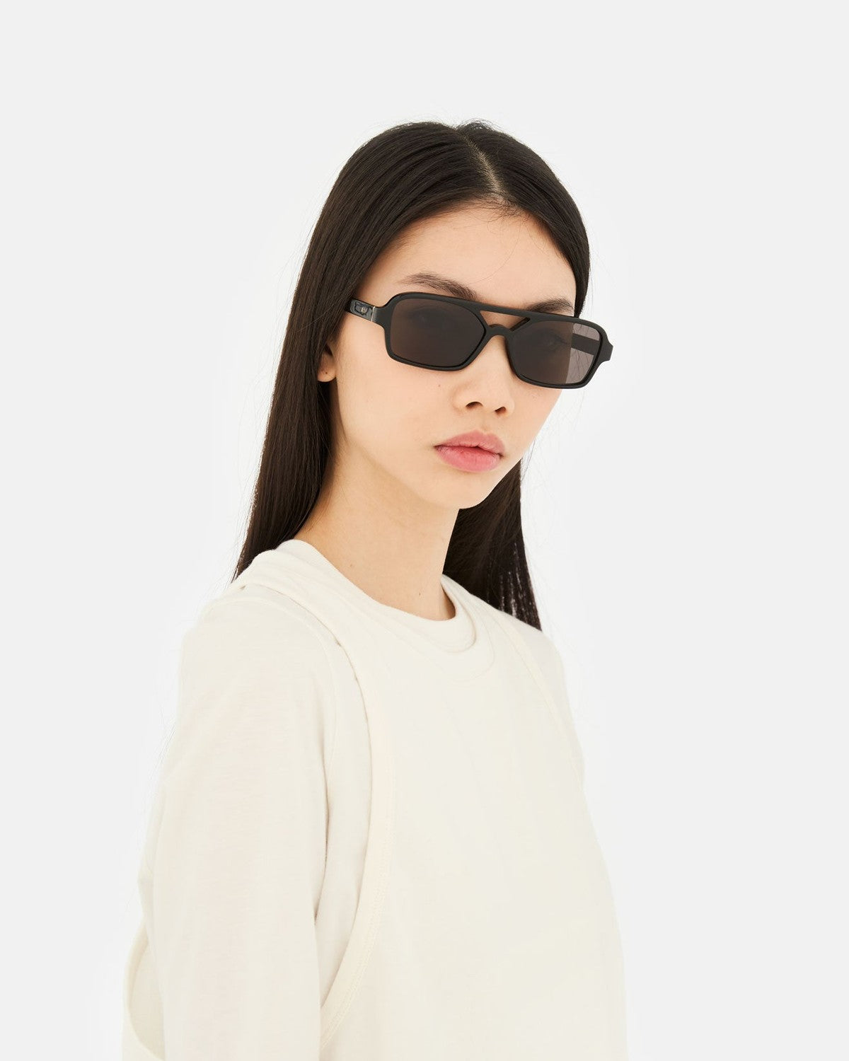 Side profile of model wearing RETROSUPERFUTURE Vico Black sunglasses.