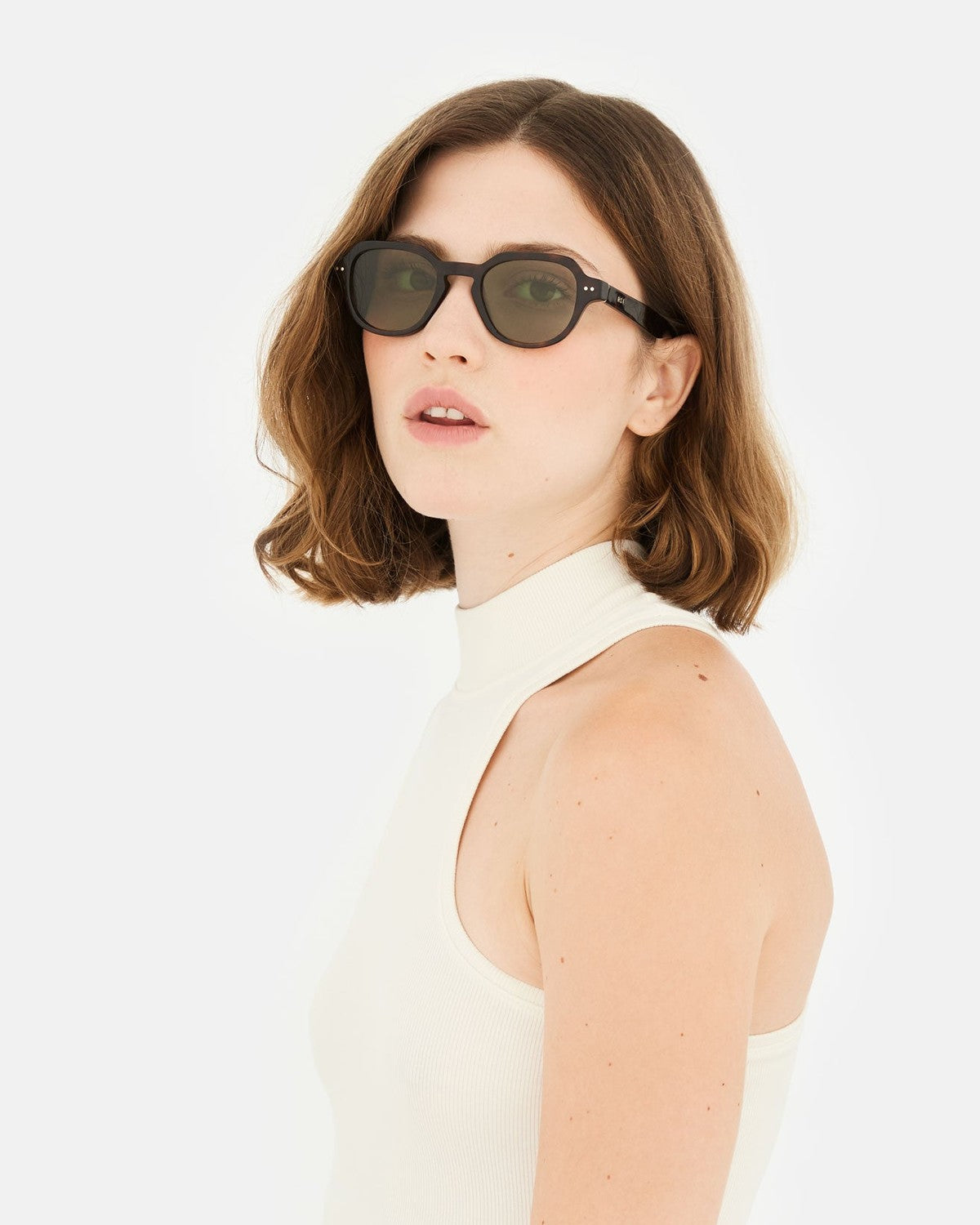 Model wearing RETROSUPERFUTURE Voce 3627 sunglasses in profile.