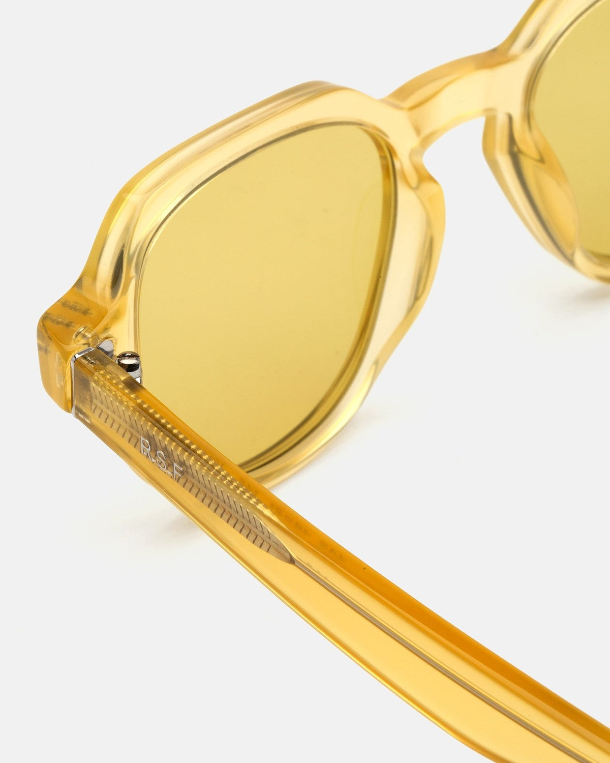 Close-up of the temple with metal hinge detail on RETROSUPERFUTURE Voce Cream sunglasses.