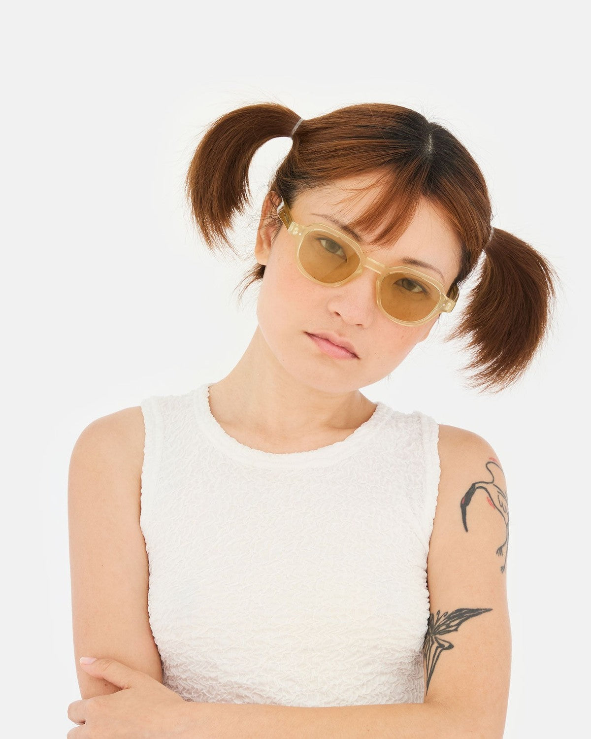 Model wearing RETROSUPERFUTURE Voce Cream sunglasses with head tilted.