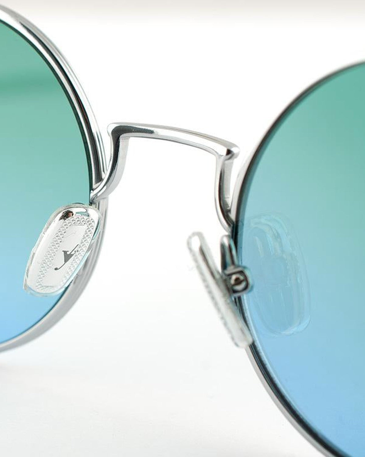 Detail of the bridge and logo-engraved nose pads on EYEPETIZER WILLIAM C.1-43F sunglasses.