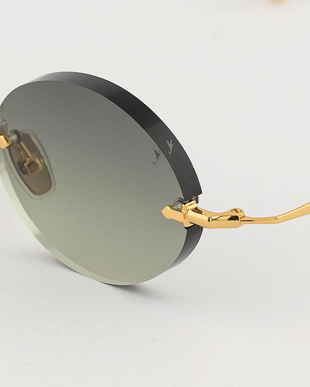 Detail of the rimless lens mounting and gold temple on EYEPETIZER WILMOT C.4-52 sunglasses.