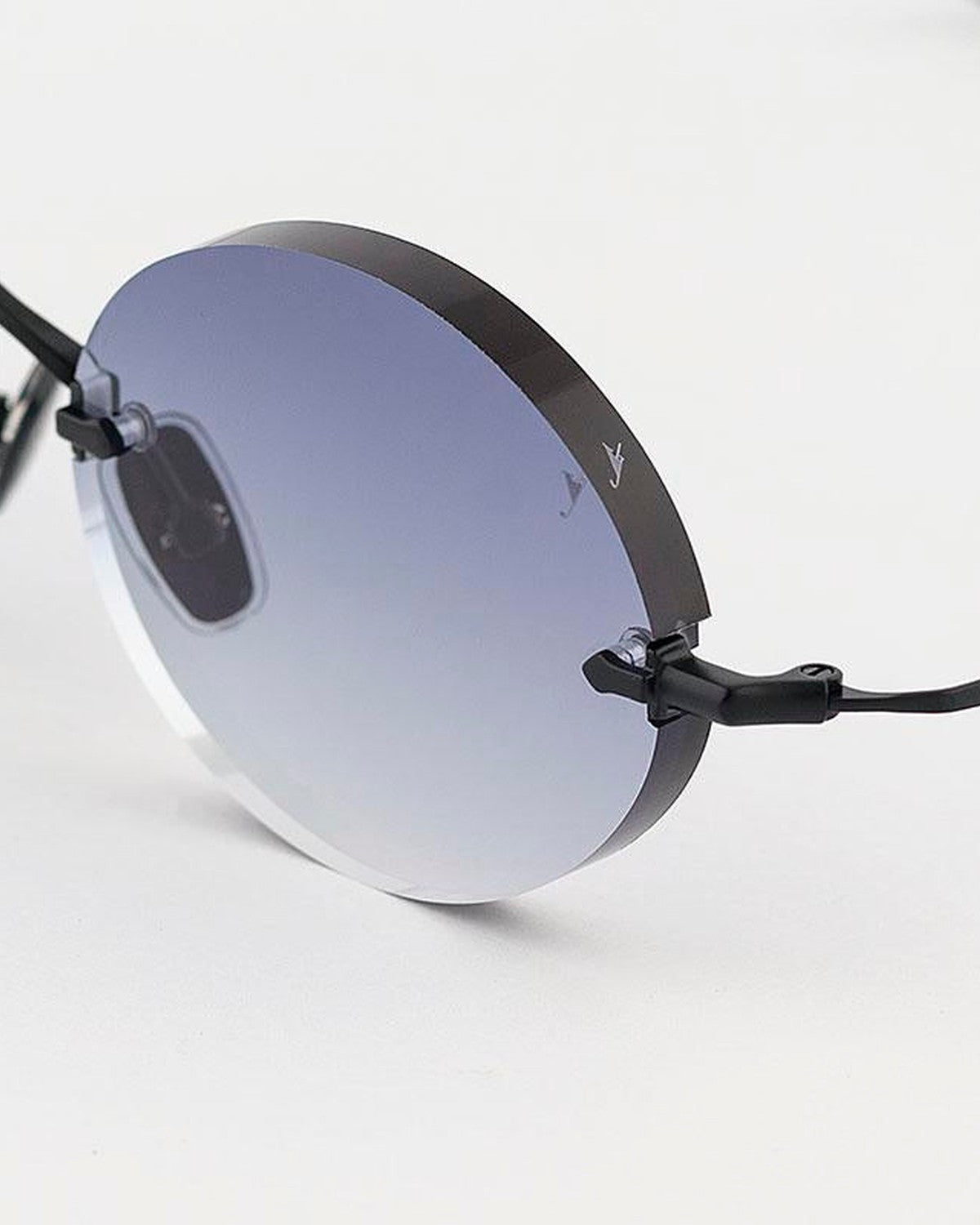 Angled close-up of the rimless lens and curved temple attachment on EYEPETIZER WILMOT C.6-51 sunglasses.