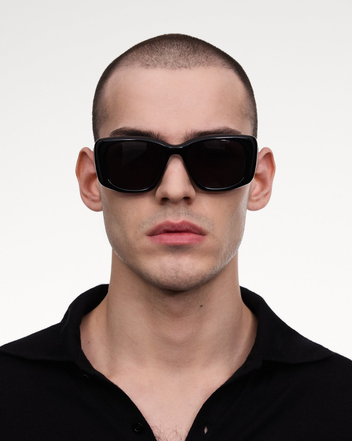 Model wearing CHIMI X15 Black Black sunglasses in a straight-on portrait.
