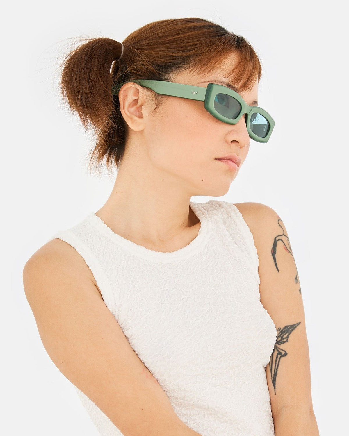 Model wearing RETROSUPERFUTURE Zaga Metallic Mint sunglasses, side profile.