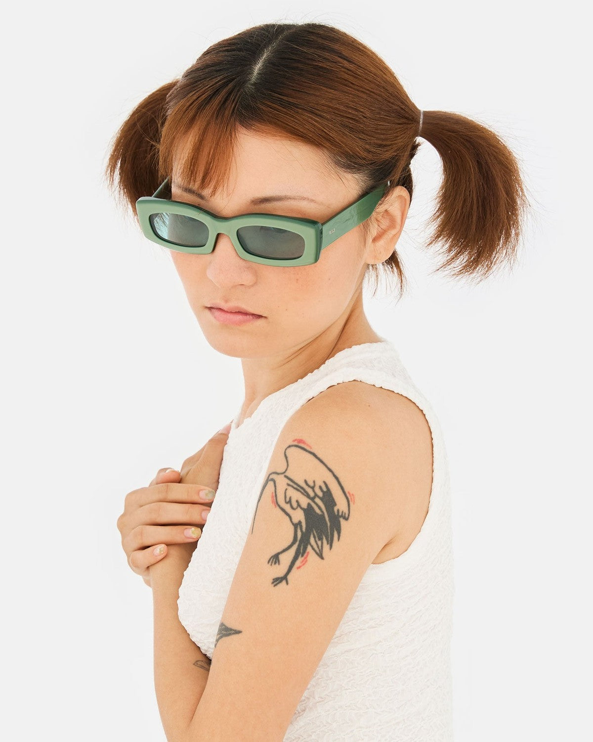 Model wearing RETROSUPERFUTURE Zaga Metallic Mint sunglasses, angled view.