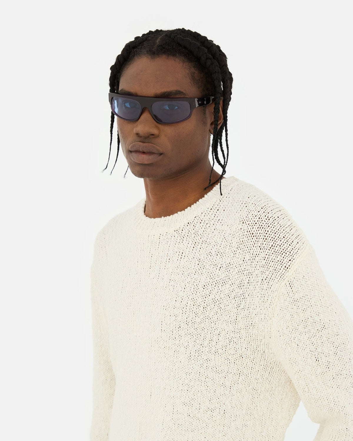 Model wearing RETROSUPERFUTURE Zam Melanzana sunglasses with knit sweater.